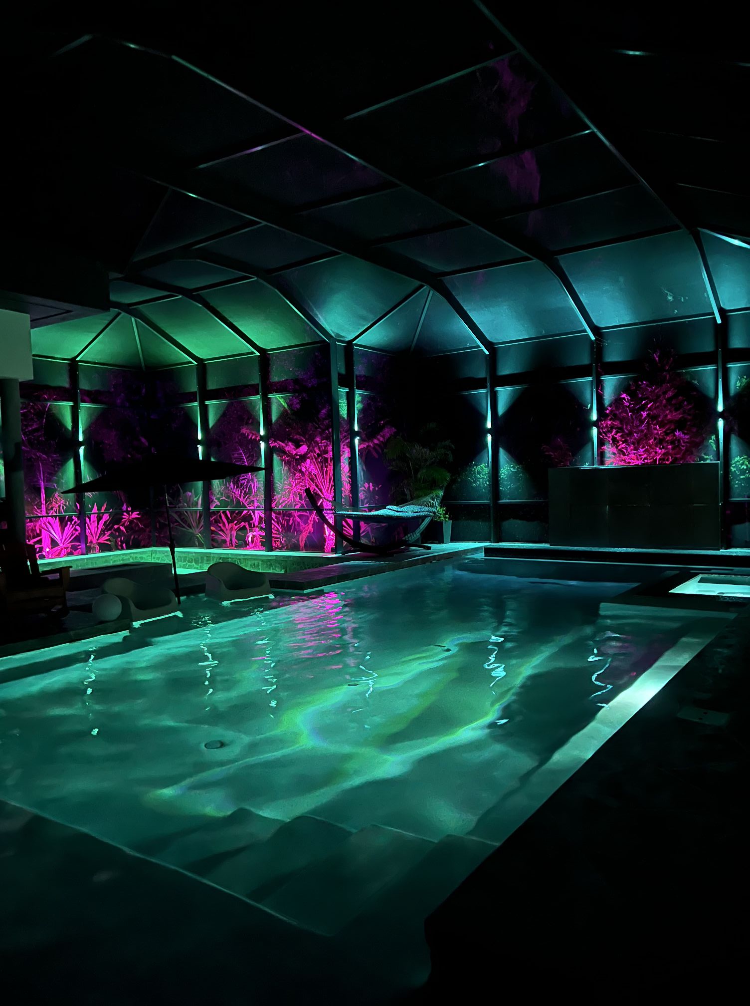 Pool cage and lanai permanent RGB lighting in green and pink, Melbourne Florida backyard